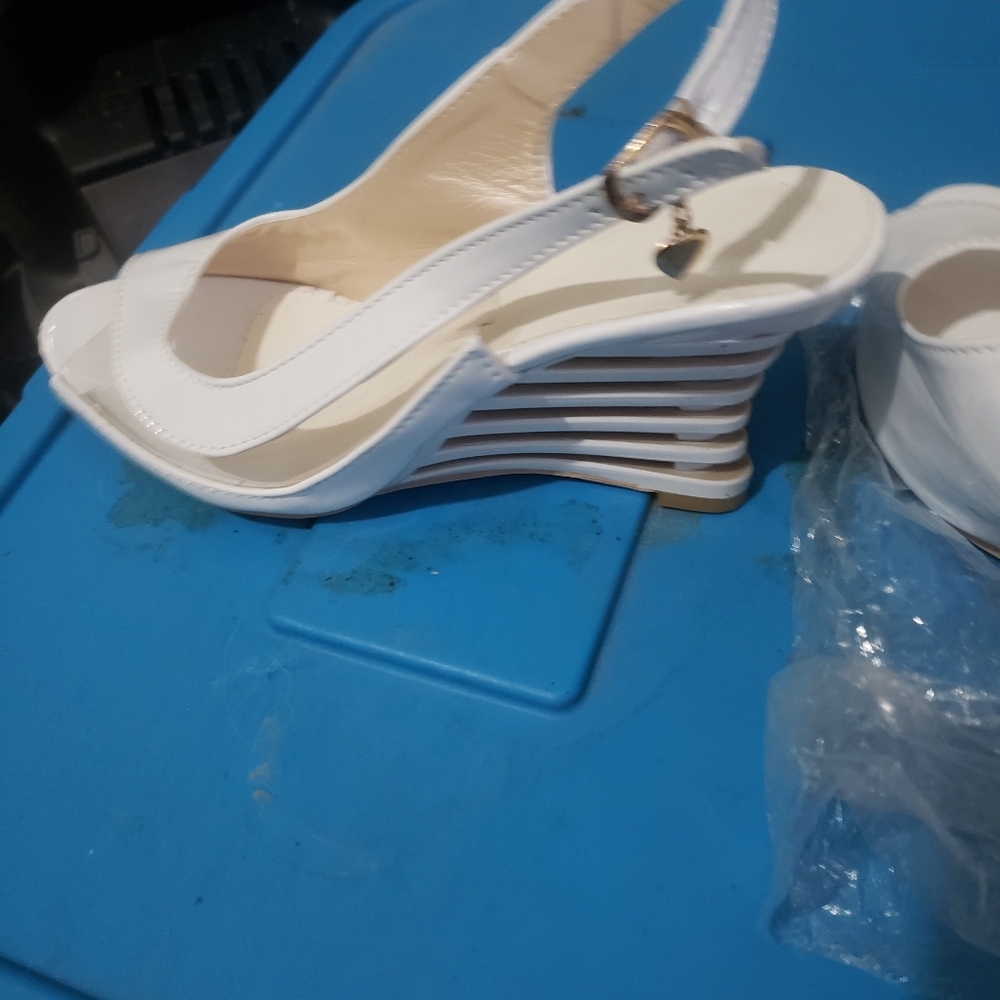 Cute white open toe shoes with heart trinket